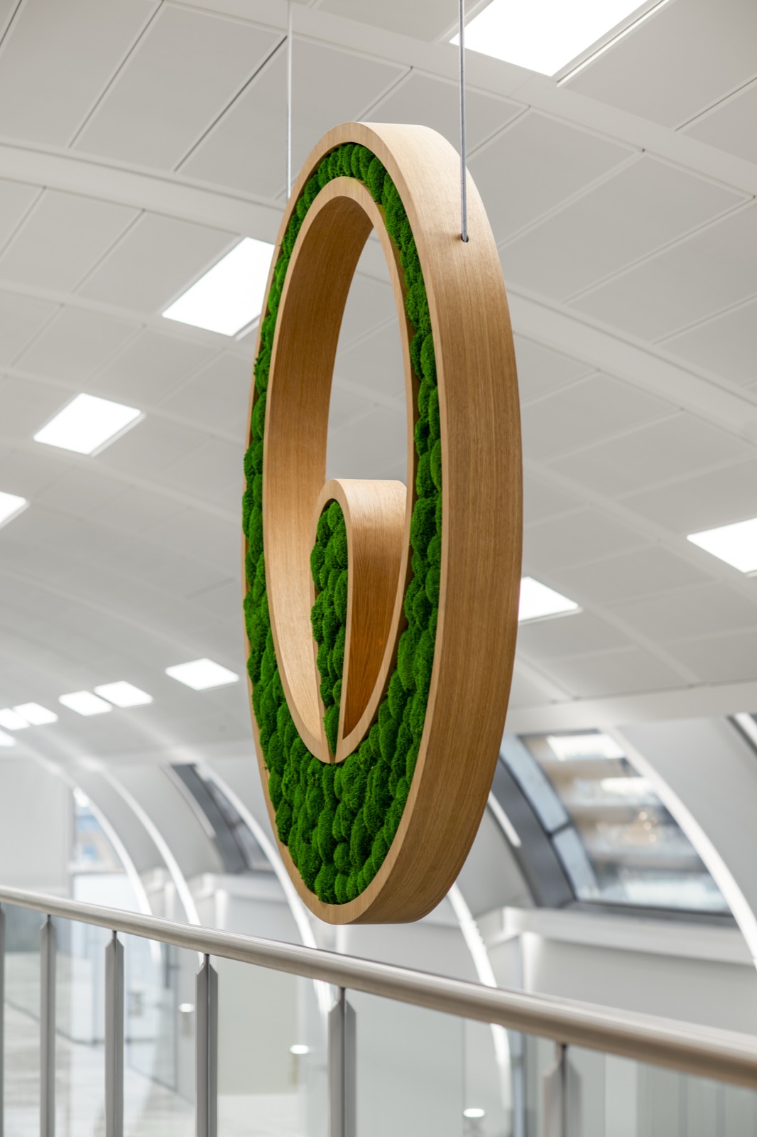 Office reception with living moss wall and natural timber finishes