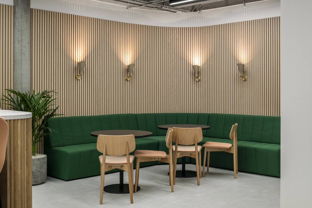 Green banquette seating with slatted timber walls