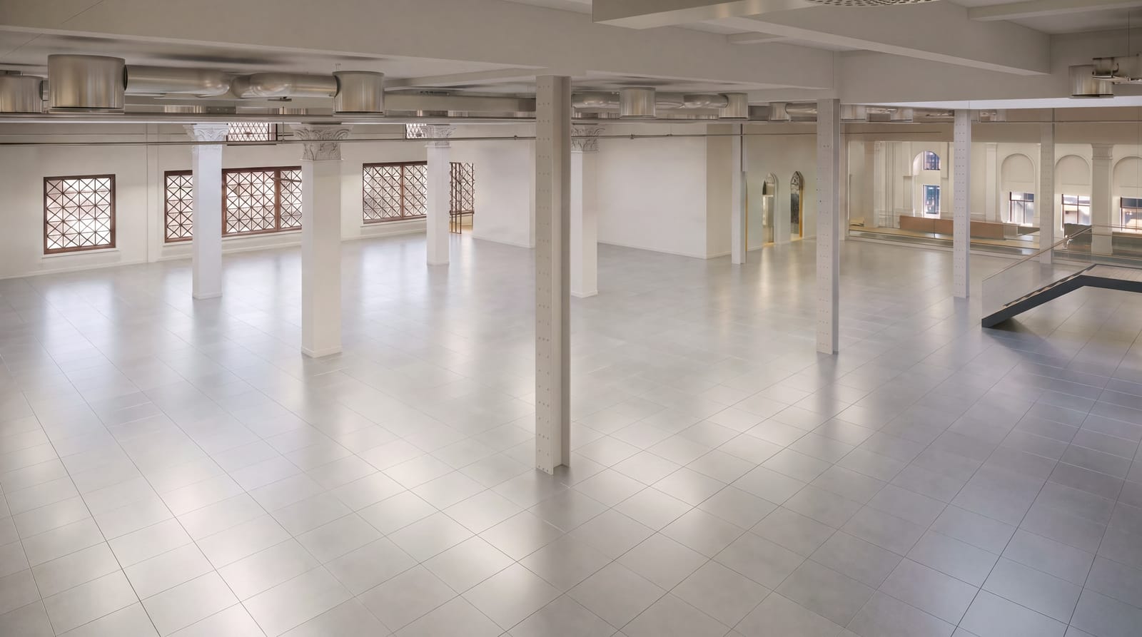 Open floor at 216 Oxford Street with original leaded windows and historic columns