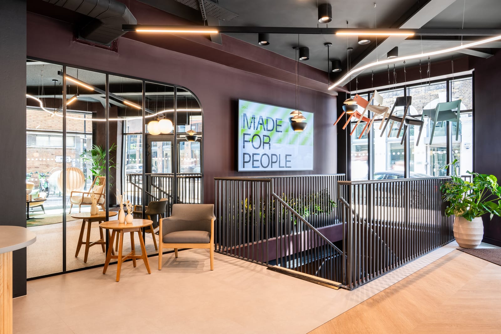 Showroom arrival with a Made for People screen, welcome seating and chairs displayed in the street-facing windows