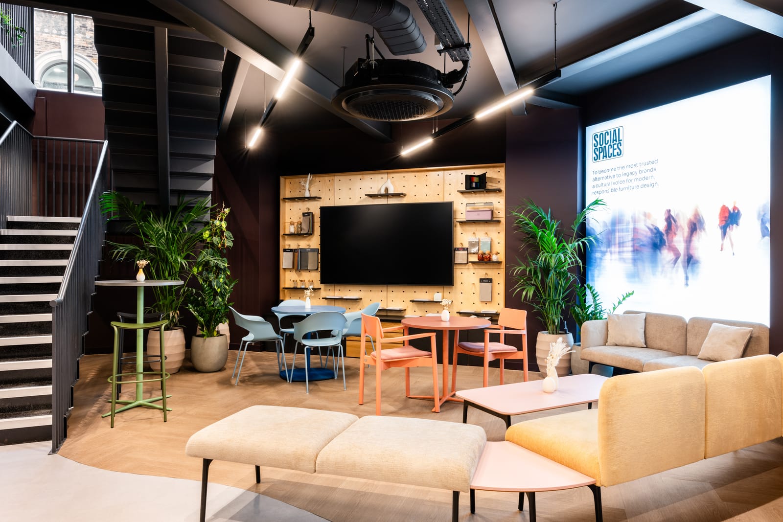 Feature wall with pegboard display joinery, a screen and Social Spaces branding