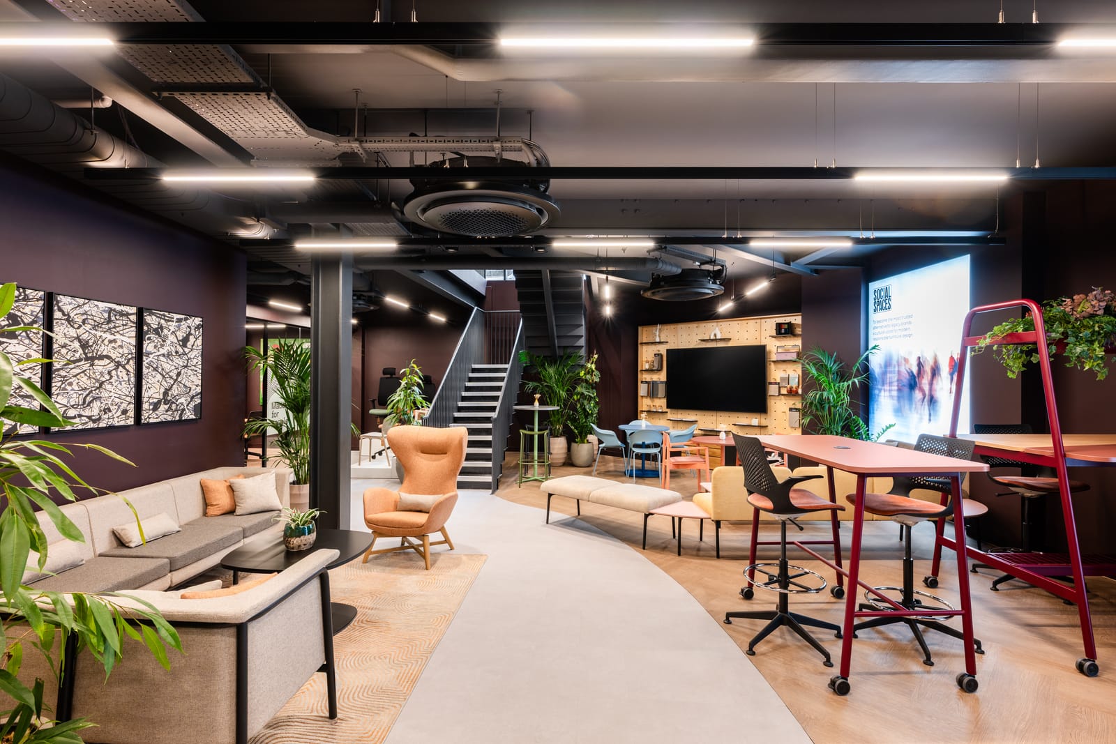 Lower ground event space with flexible settings, a presentation screen and the staircase