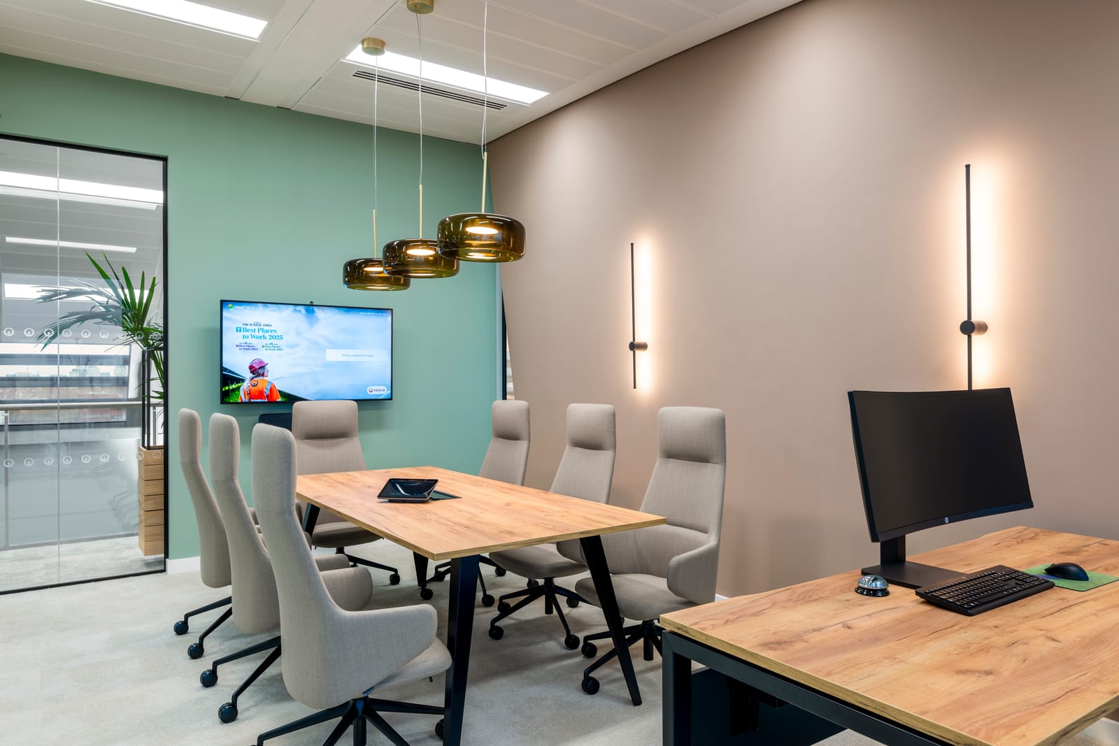 Large boardroom with herringbone rug, arched acoustic panel and city views