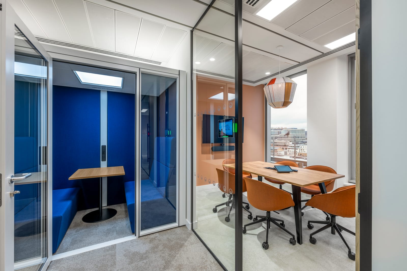 Phone booth and small meeting room with blue interior and warm leather chairs