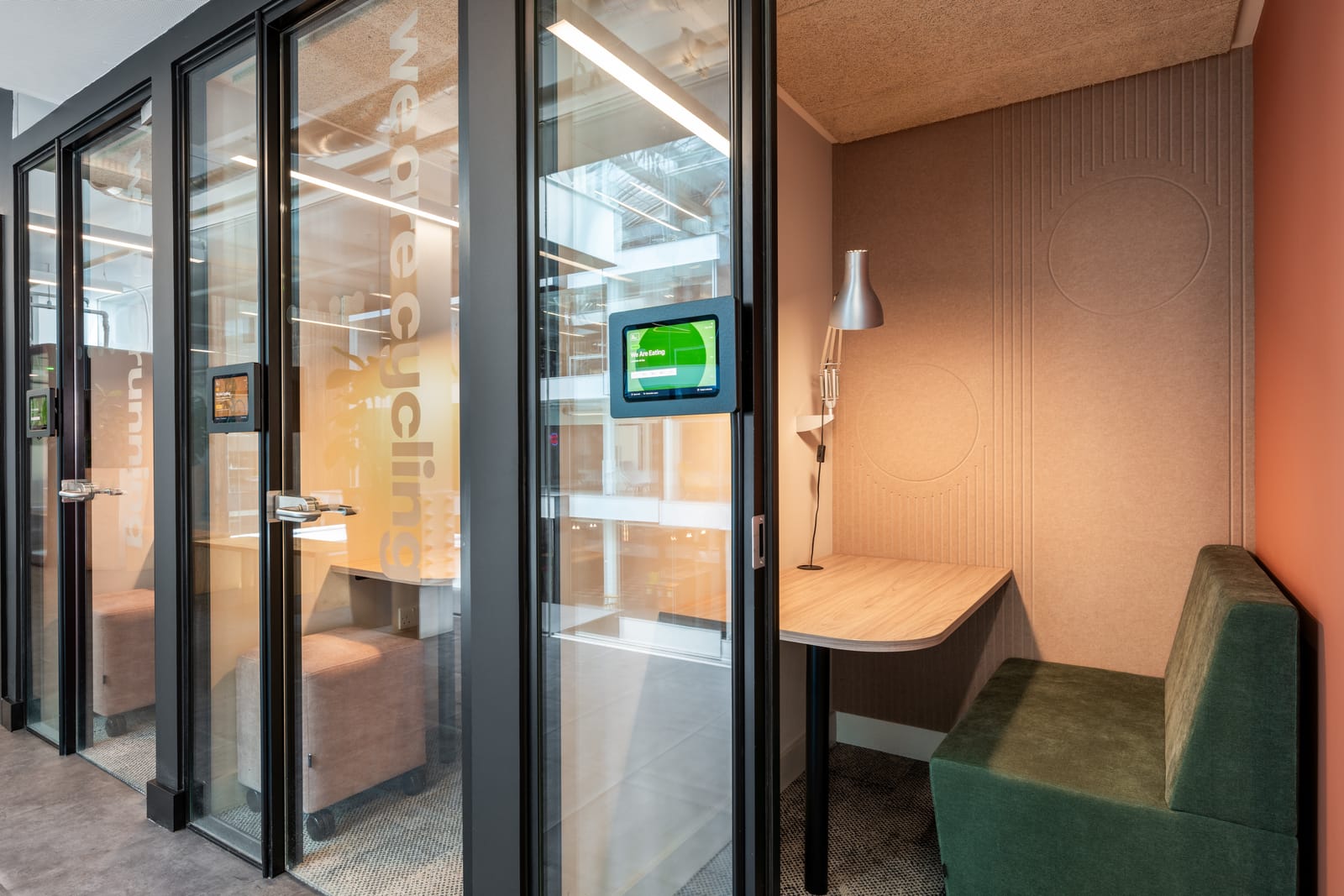 Focus booth with a green velvet banquette, angled oak desk and routed acoustic felt walls